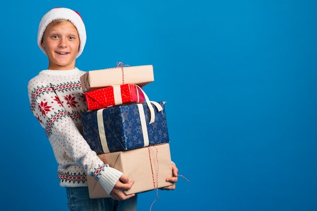 Boy holding christmas presents