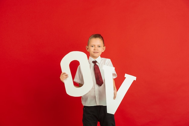 Boy holding letters O and V