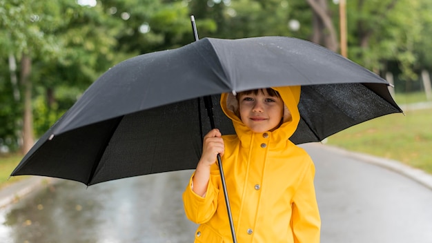 Boy holding an opened umbrella