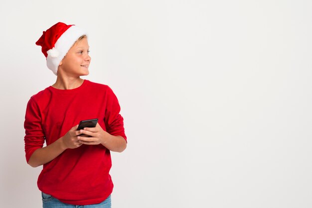 Boy holding phone looking away