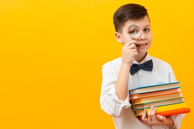 Boy holding stack of books