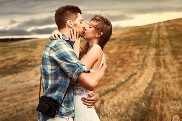 Boy hugging his girlfriend and kissing passionately