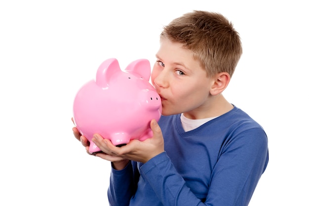 Free photo boy kissing pink piggybank on white space