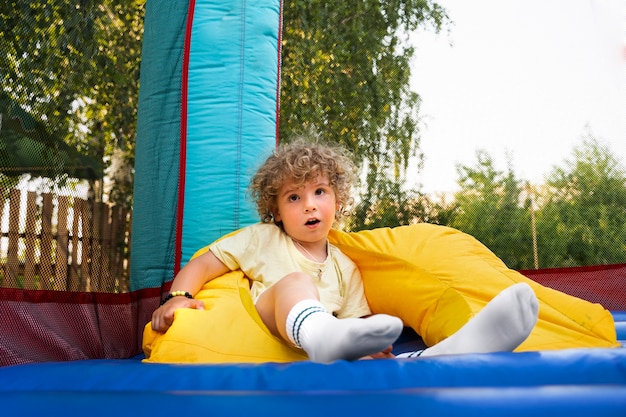 Boy laying in bounce house full shot