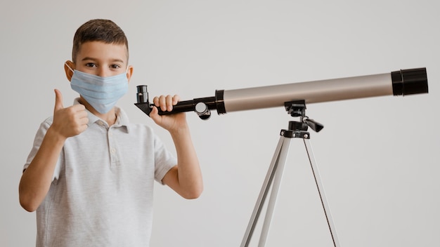 Boy learning how to use a telescope