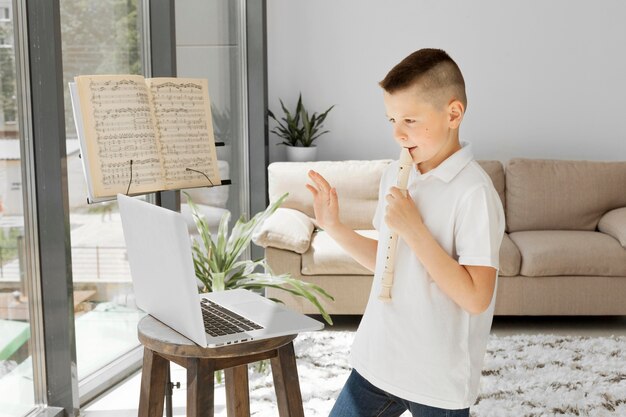 Boy learning online courses from laptop