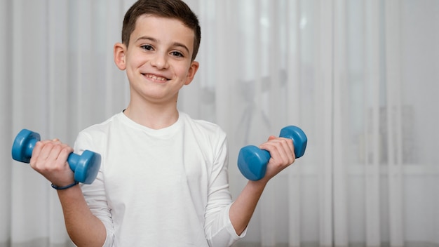 Boy lifting dumbbells workout exercises