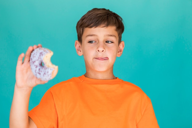 Boy looking at delicious glazed doughnut