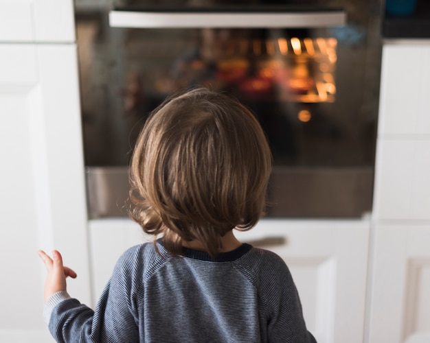 Boy looking at oven