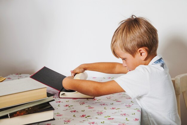 Boy looking through book