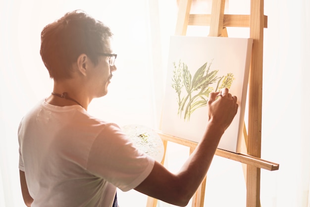 Boy painting on canvas