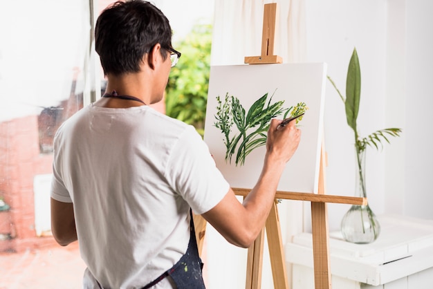 Boy painting on canvas