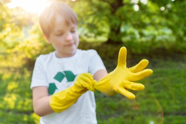 Boy at plastic garbage collection in a park