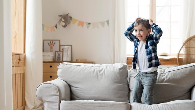 Boy playing on the sofa