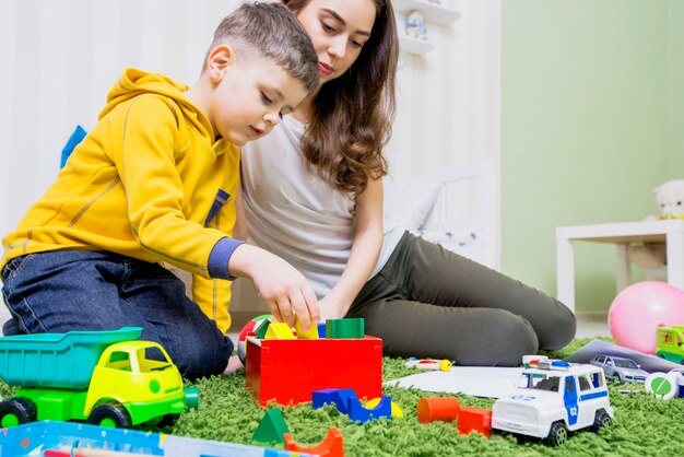 Boy playing toys with woman