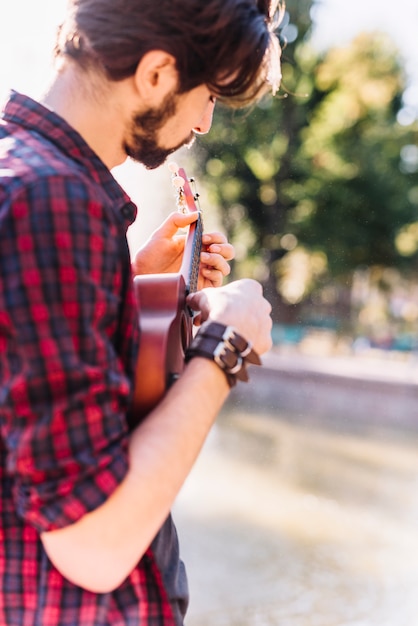 Free photo boy playing the ukelele