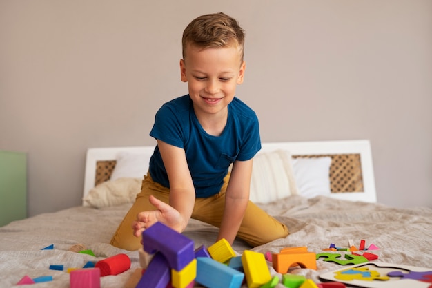 Free photo boy playing with brain teaser toys