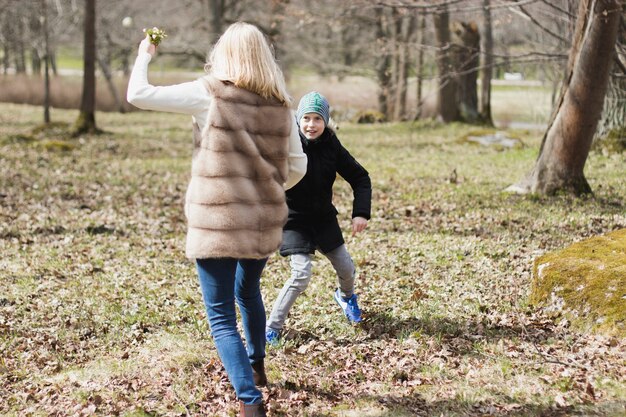 Boy playing with his mother in the park