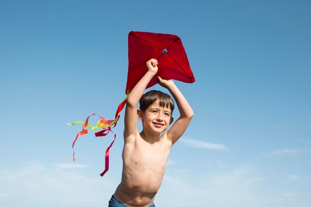 Boy playing with kite medium shot