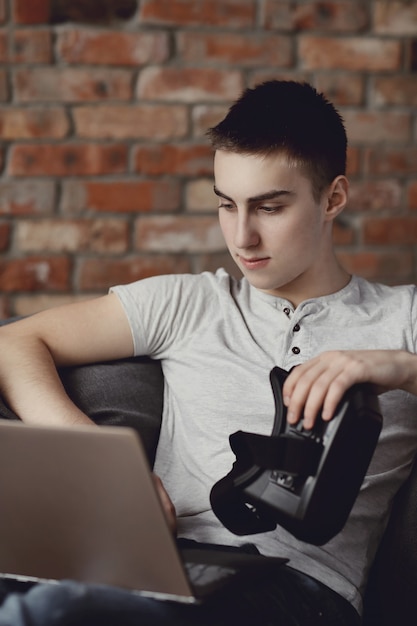 Boy playing with VR headset at home