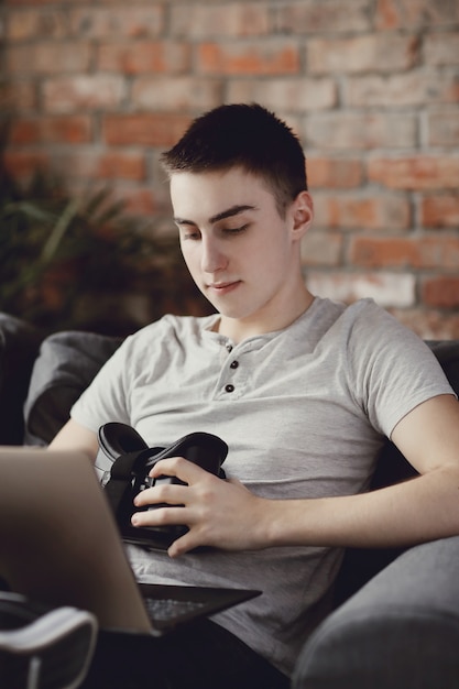 Boy playing with VR headset at home