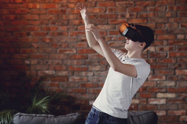 Boy playing with VR headset at home