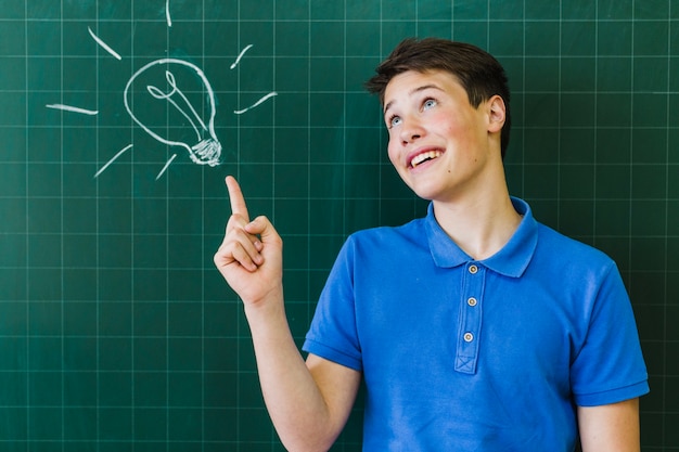 Boy pointing the blackboard