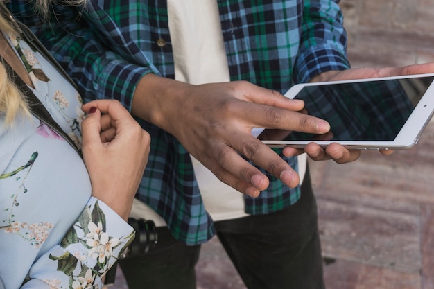 Boy pointing at smartphone screen