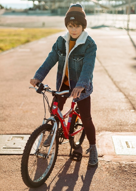 Boy posing while riding his bike