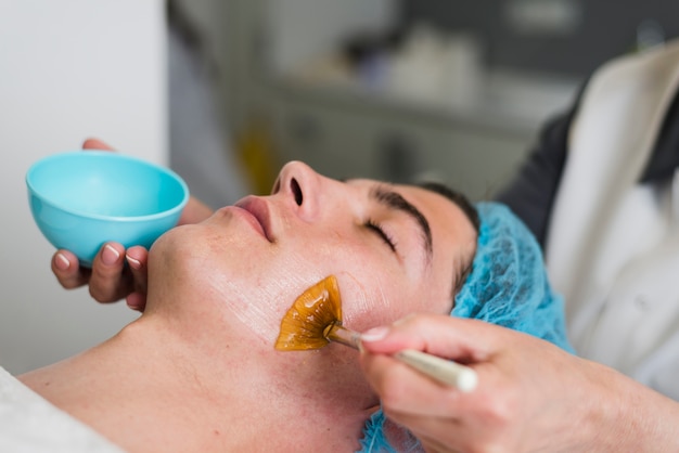 Boy receiving facial treatment in a beauty salon