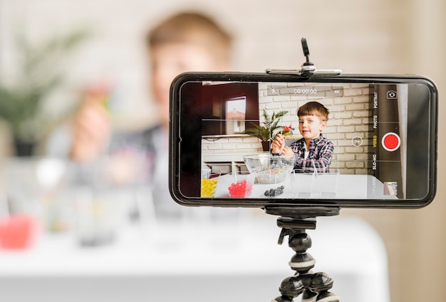 Boy recording himself with smartphone