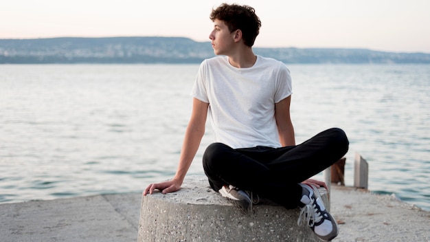 Free photo boy relaxing and spending time at sea