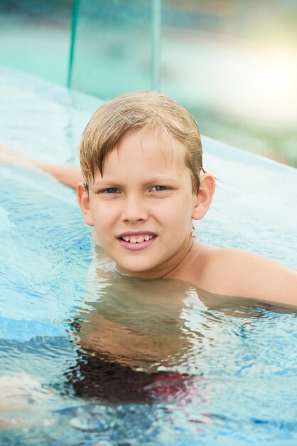 Boy relaxing in swimming pool