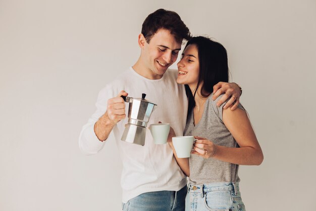 Boy serving coffee to his girlfriend