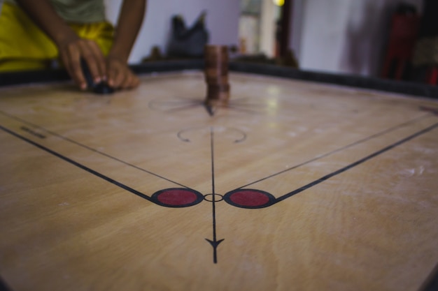 Boy setting up a carroms board