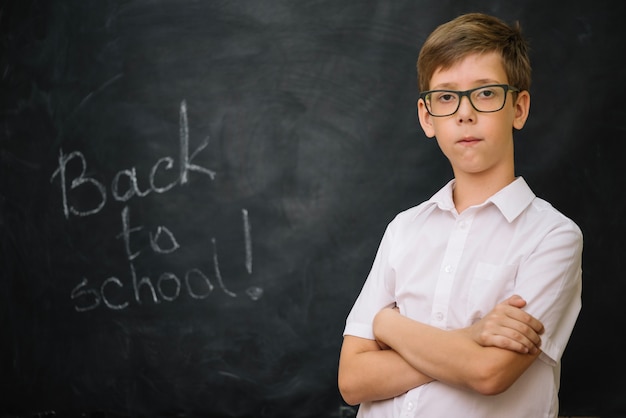 Boy in shirt holding arms crossed standing