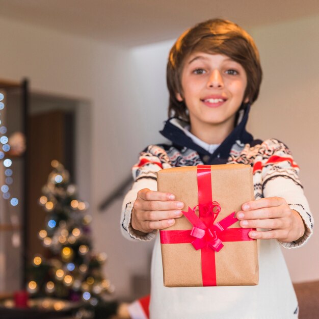 Boy showing present box 