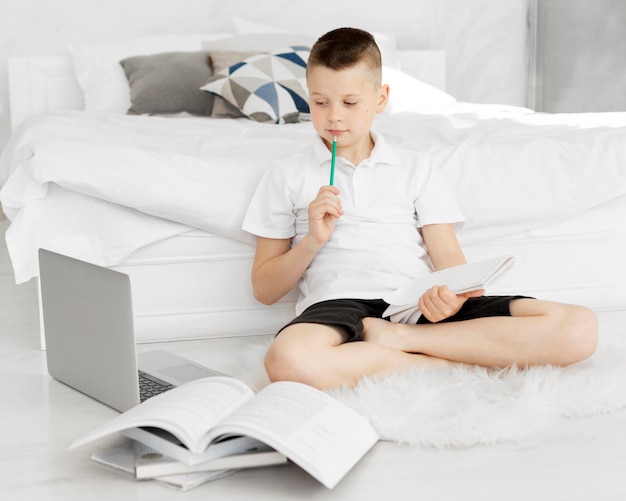 Boy sitting on the floor and learning