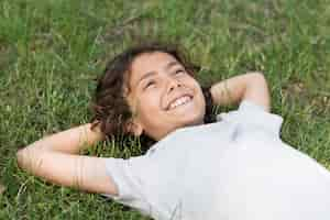 Free photo boy sitting in grass