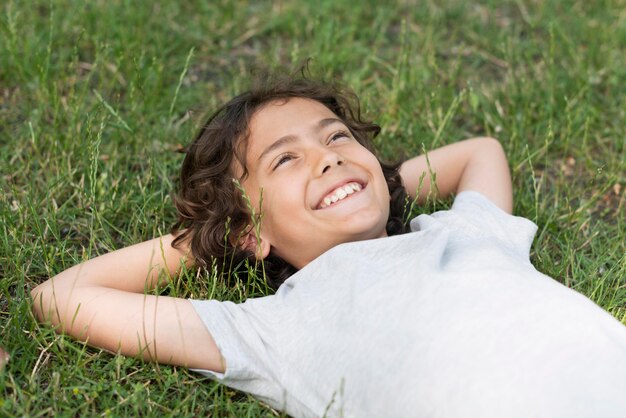 Boy sitting in grass