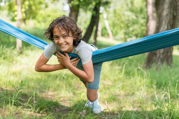 Free photo boy sitting in hammock