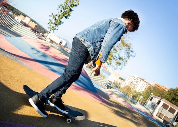 Free photo boy skateboarding at the park alone