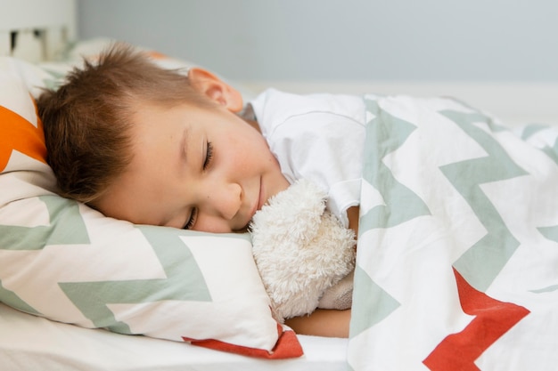 Boy sleeping with his favorite toy