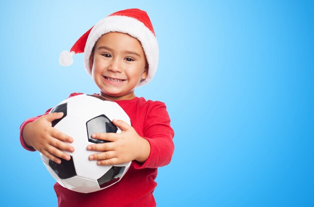 Boy smiling while showing his ball