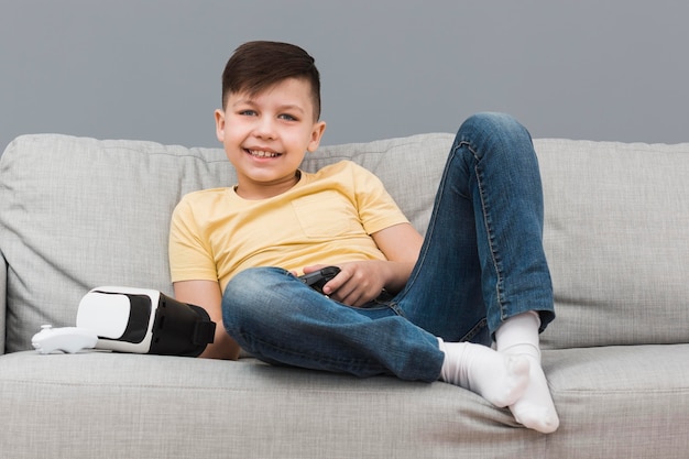 Boy on sofa playing video games