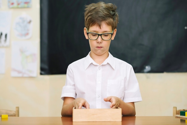 Boy at table with game