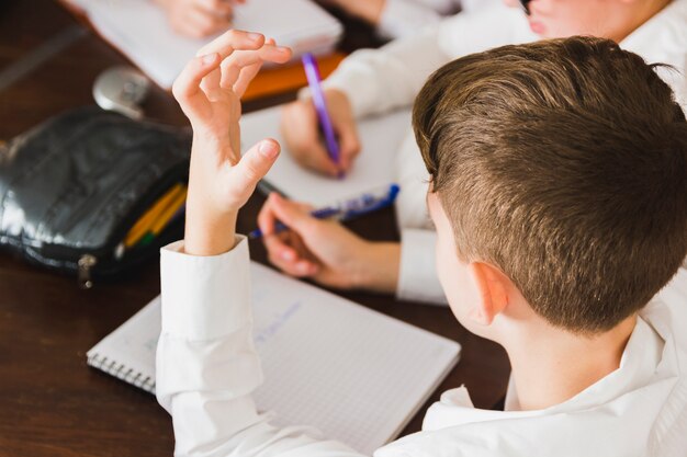 Boy thinking doing homework at desk 