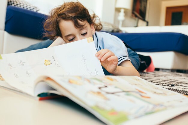 Boy turning pages of textbook