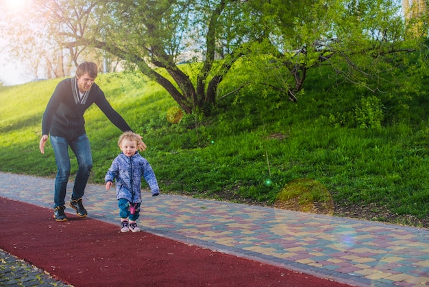 Boy walking with his father behind