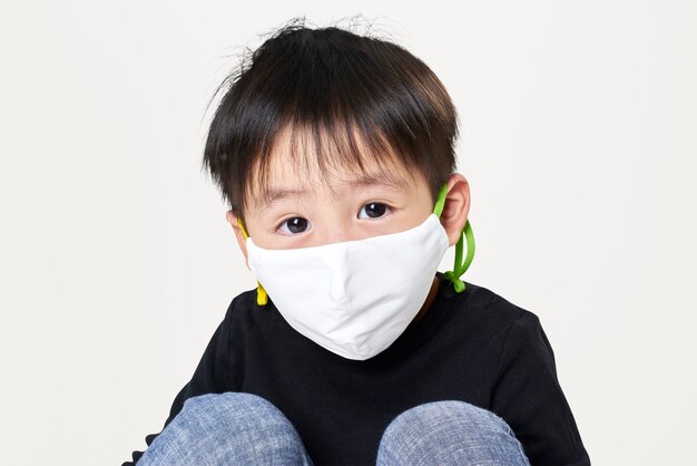 Boy wearing white face mask